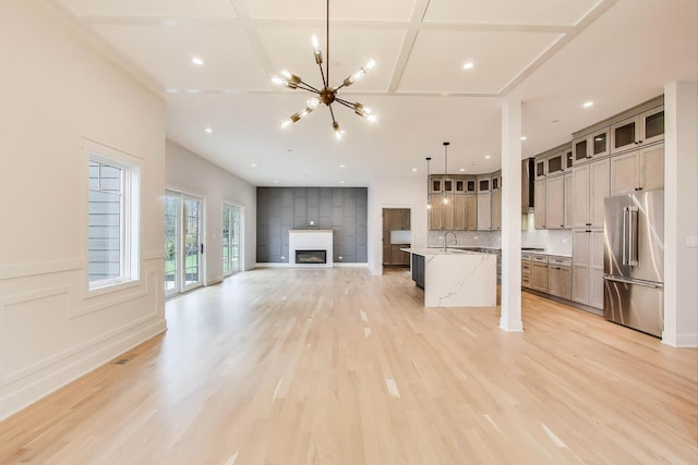 7302 Ponto Ct, Morton Grove, IL 60053 - unfurnished living room featuring a sink, a chandelier, a large fireplace, light wood-type flooring, and recessed lighting