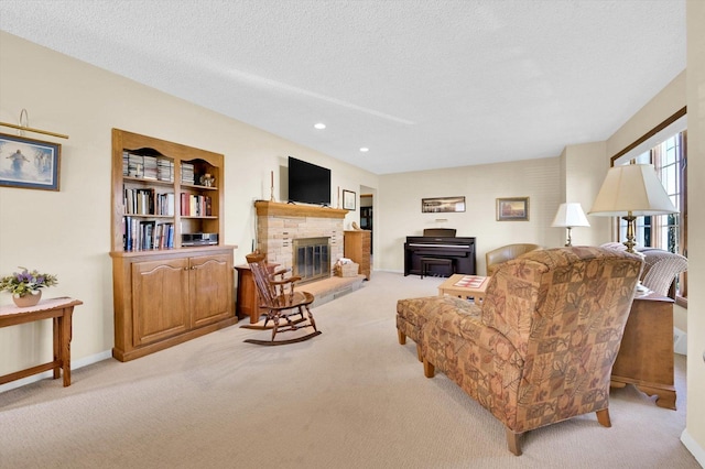 living room with light carpet, a textured ceiling, and a glass covered fireplace