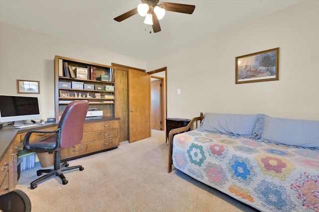 bedroom with a ceiling fan and light colored carpet