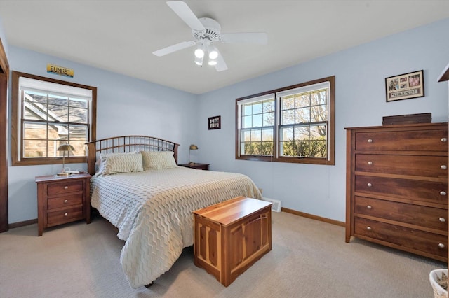bedroom with baseboards, a ceiling fan, and light colored carpet