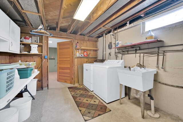 laundry room with a sink, washer and dryer, and cabinet space