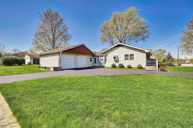 ranch-style house with a garage, aphalt driveway, and a front yard