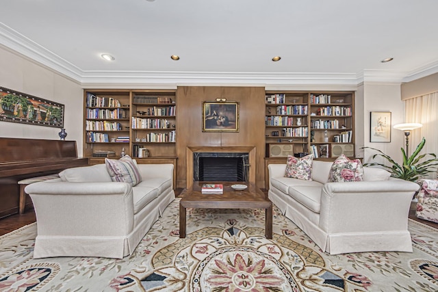 living room featuring a high end fireplace, crown molding, and built in features
