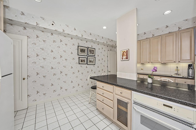kitchen featuring light brown cabinetry, baseboards, recessed lighting, wallpapered walls, and light tile patterned floors