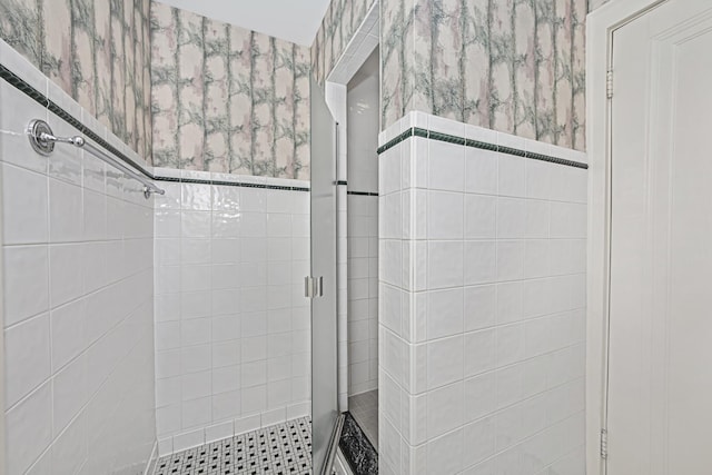 full bath with a shower stall and wallpapered walls