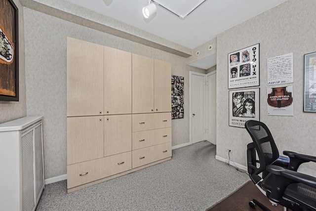 carpeted office with wallpapered walls and baseboards