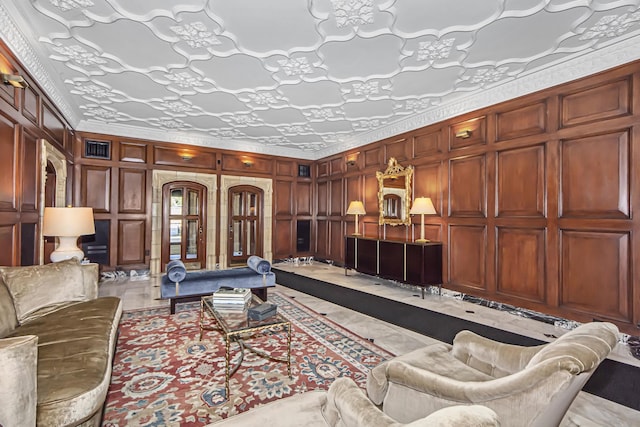 living area featuring arched walkways, crown molding, and visible vents