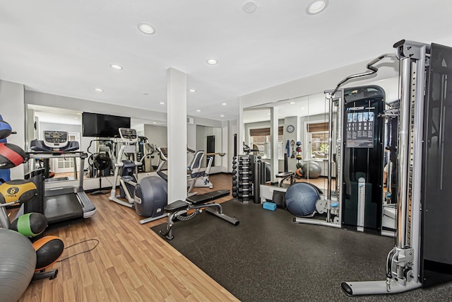 gym with wood finished floors and recessed lighting