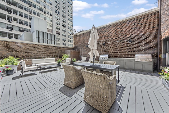deck featuring outdoor dining area, an outdoor hangout area, exterior kitchen, and area for grilling