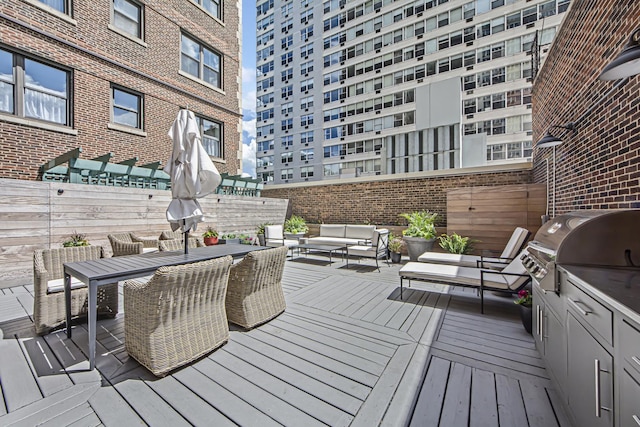 deck featuring outdoor lounge area, outdoor dining area, exterior kitchen, and a grill