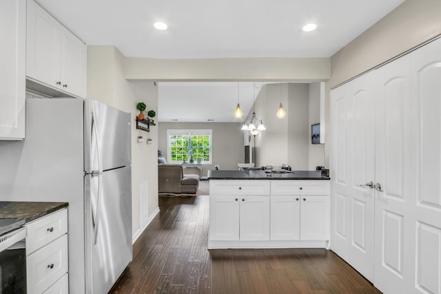 104 E Winchester Rd Unit E, Libertyville, IL 60048 - kitchen with dark wood-type flooring, white cabinets, open floor plan, freestanding refrigerator, and a peninsula