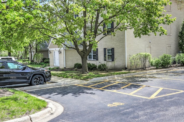 104 E Winchester Rd Unit E, Libertyville, IL 60048 - view of side of home featuring uncovered parking and brick siding