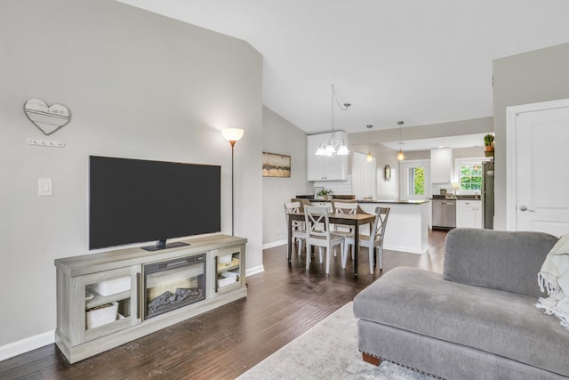 104 E Winchester Rd Unit E, Libertyville, IL 60048 - living room with vaulted ceiling, a chandelier, dark wood-style flooring, and baseboards