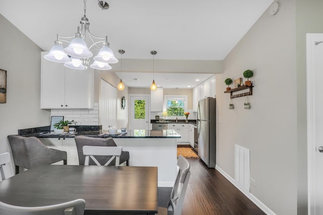 104 E Winchester Rd Unit E, Libertyville, IL 60048 - dining room featuring dark wood-type flooring, a chandelier, and baseboards