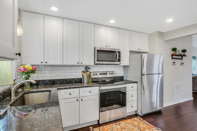 104 E Winchester Rd Unit E, Libertyville, IL 60048 - kitchen with stainless steel appliances, a sink, decorative backsplash, baseboards, and white cabinetry
