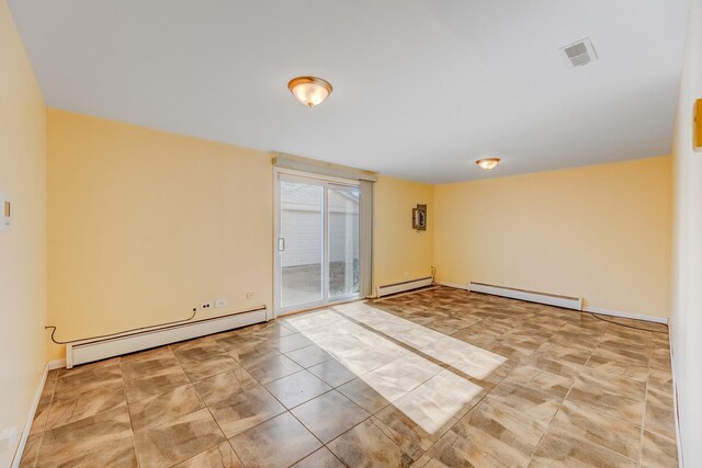 tiled empty room featuring baseboard heating, a baseboard heating unit, and baseboards