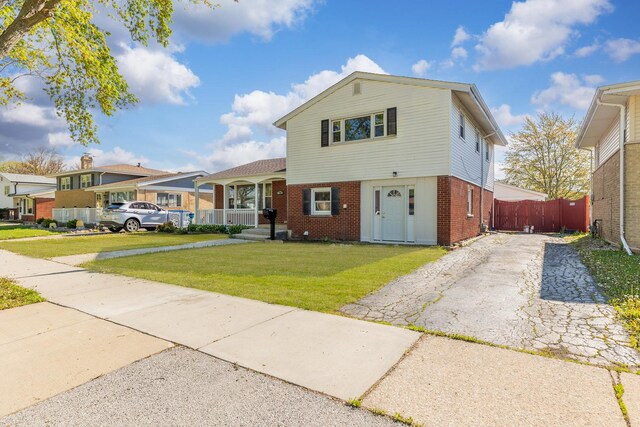 split level home with brick siding and asphalt driveway