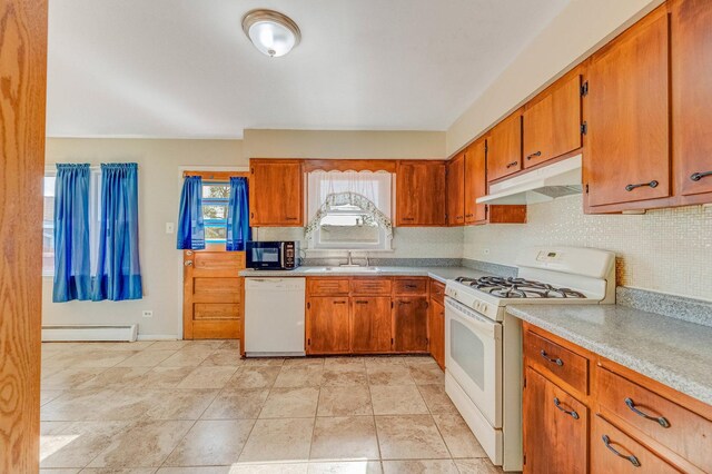 kitchen featuring white appliances, under cabinet range hood, a baseboard radiator, backsplash, and light countertops