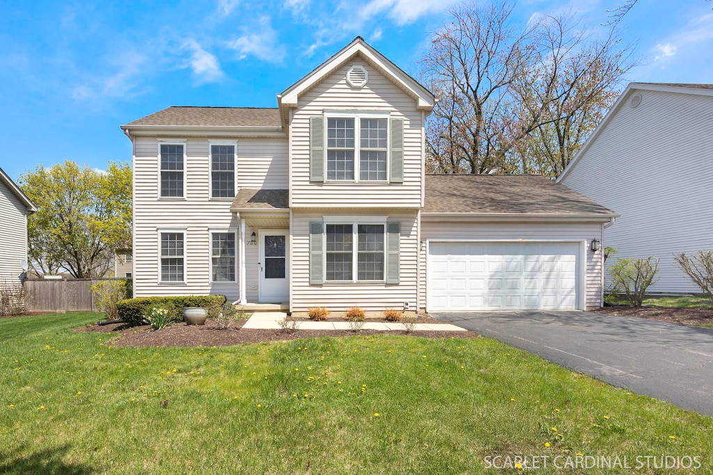 700 Cooper Ct E, Aurora, IL 60504 - traditional home featuring driveway, fence, a front yard, and a garage