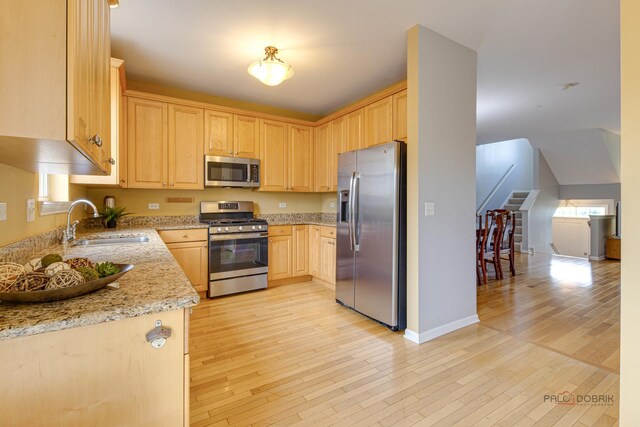 1123 E Port Clinton Rd, Vernon Hills, IL 60061 - kitchen featuring stainless steel appliances, light brown cabinets, a sink, light stone counters, and light wood finished floors
