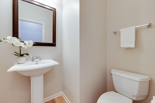 1123 E Port Clinton Rd, Vernon Hills, IL 60061 - bathroom with toilet, wood finished floors, and baseboards