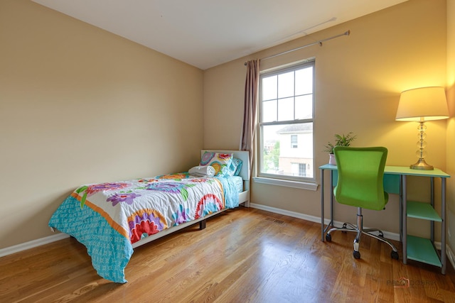 1123 E Port Clinton Rd, Vernon Hills, IL 60061 - bedroom featuring multiple windows, baseboards, and wood finished floors