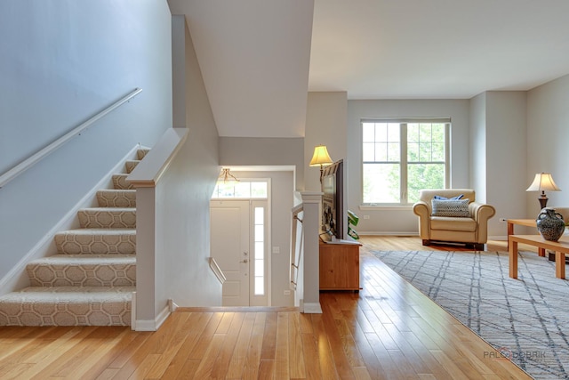 1123 E Port Clinton Rd, Vernon Hills, IL 60061 - foyer with healthy amount of natural light, wood finished floors, baseboards, and stairs