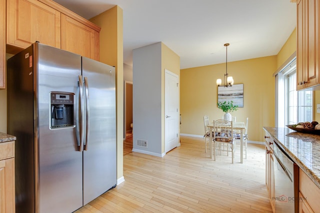 1123 E Port Clinton Rd, Vernon Hills, IL 60061 - kitchen featuring stainless steel appliances, a chandelier, stone counters, baseboards, and light wood finished floors