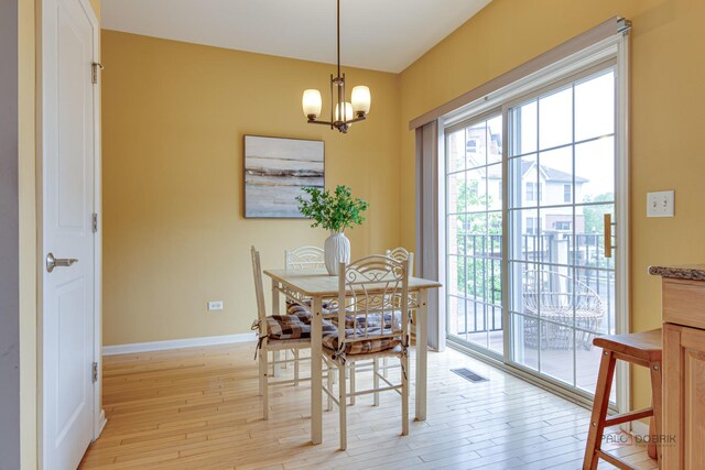 1123 E Port Clinton Rd, Vernon Hills, IL 60061 - dining area featuring light wood finished floors, a chandelier, and baseboards