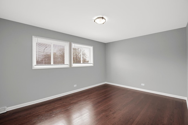 16460 Wood St, Markham, IL 60428 - unfurnished room featuring visible vents, baseboards, and dark wood-type flooring