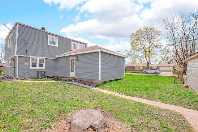 16460 Wood St, Markham, IL 60428 - rear view of house with fence, a lawn, and central AC unit
