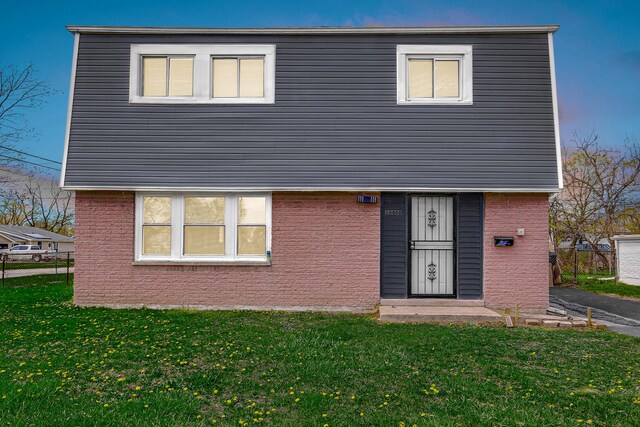 16460 Wood St, Markham, IL 60428 - colonial home with brick siding, fence, and a front yard