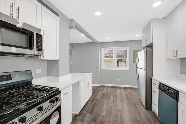 16460 Wood St, Markham, IL 60428 - kitchen with light stone counters, white cabinetry, appliances with stainless steel finishes, and dark wood-style flooring
