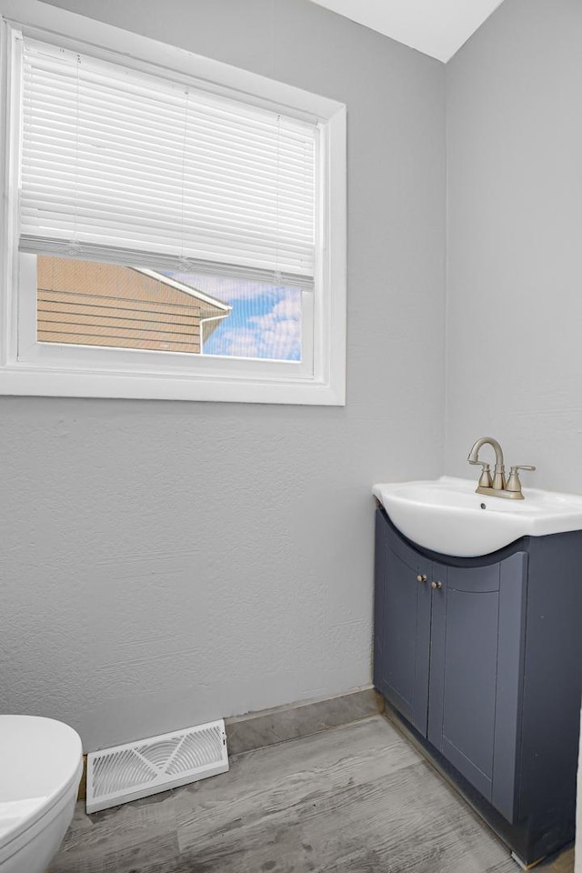 16460 Wood St, Markham, IL 60428 - bathroom featuring wood finished floors, visible vents, toilet, vanity, and baseboards