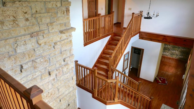 2346 W Longhollow Rd, Elizabeth, IL 61028 - stairway with wood finished floors and a chandelier