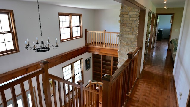2346 W Longhollow Rd, Elizabeth, IL 61028 - hallway with an upstairs landing, a chandelier, and wood finished floors