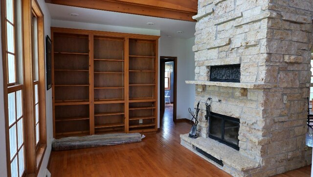 2346 W Longhollow Rd, Elizabeth, IL 61028 - unfurnished living room featuring a fireplace, wood finished floors, and baseboards