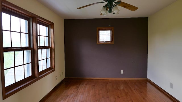 2346 W Longhollow Rd, Elizabeth, IL 61028 - empty room featuring hardwood / wood-style floors, ceiling fan, and baseboards