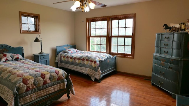 2346 W Longhollow Rd, Elizabeth, IL 61028 - bedroom with light wood-style flooring, baseboards, and ceiling fan