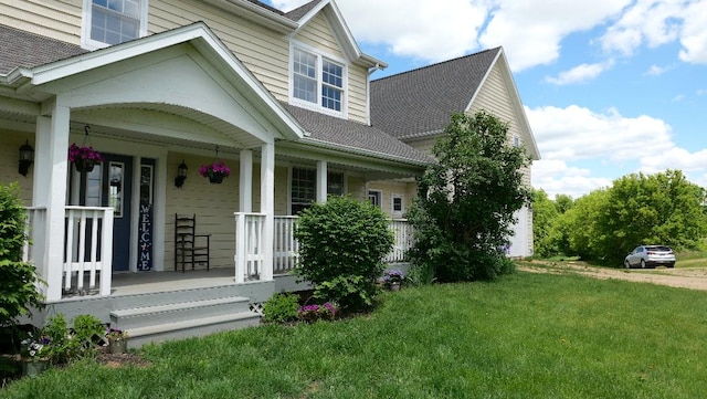 2346 W Longhollow Rd, Elizabeth, IL 61028 - view of side of home with covered porch, a yard, and roof with shingles