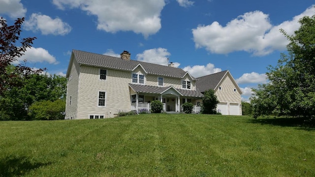 2346 W Longhollow Rd, Elizabeth, IL 61028 - view of front of property with a porch, a chimney, a front yard, metal roof, and a standing seam roof