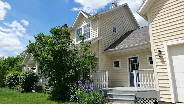 2346 W Longhollow Rd, Elizabeth, IL 61028 - rear view of property featuring a deck, a chimney, and a shingled roof