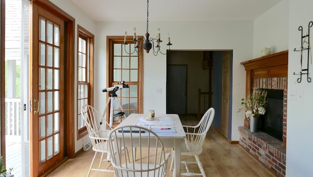2346 W Longhollow Rd, Elizabeth, IL 61028 - dining area featuring light wood-style floors, a chandelier, and baseboards