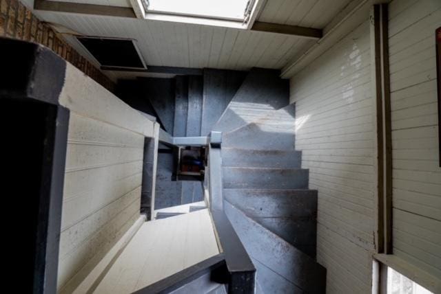 stairway with wooden walls