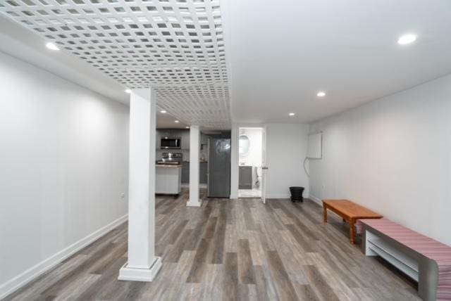 finished basement with recessed lighting, baseboards, and wood finished floors