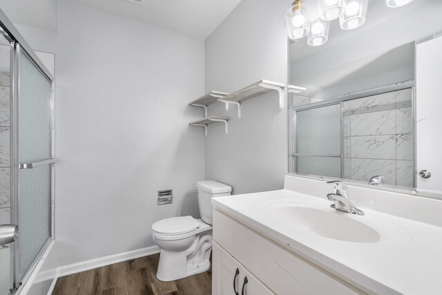 215 S Hale St Unit 9B, Addison, IL 60101 - bathroom featuring shower / bath combination with glass door, wood finished floors, toilet, vanity, and baseboards
