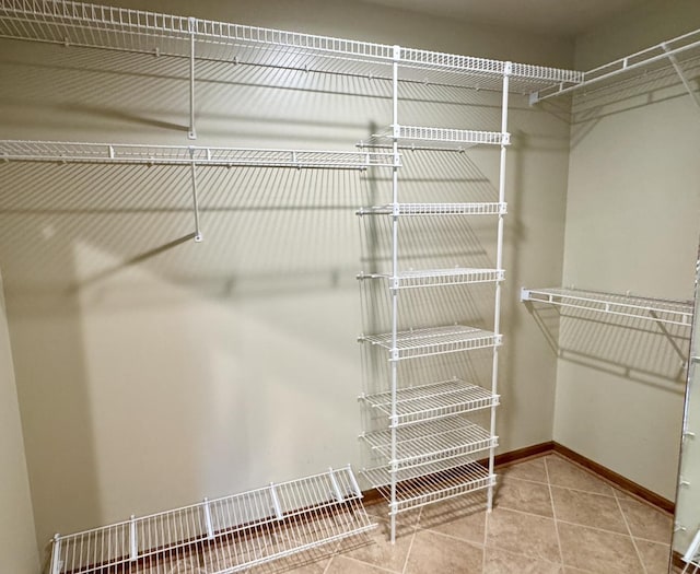 spacious closet featuring tile patterned flooring