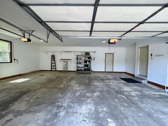 garage with baseboards and a garage door opener