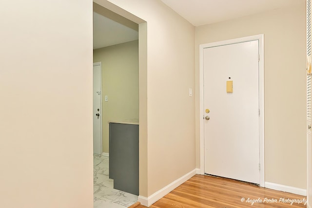 entryway with light wood-style floors and baseboards