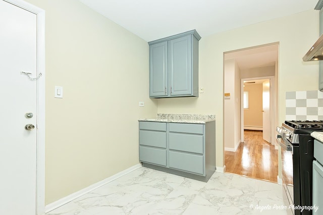 interior space with baseboards, baseboard heating, and marble finish floor